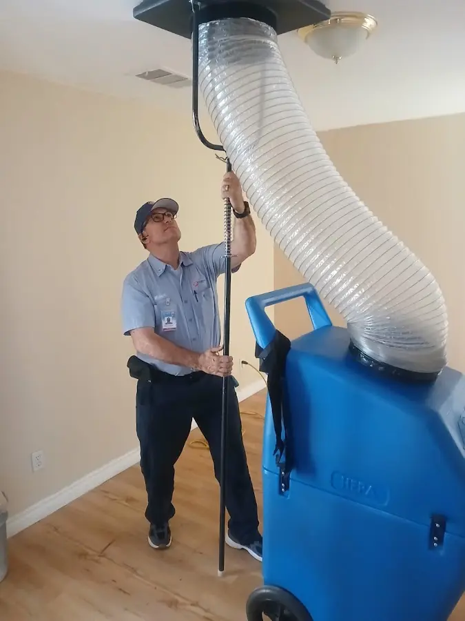 Furnace Tune-Up technician using HEPA equipment in Camano